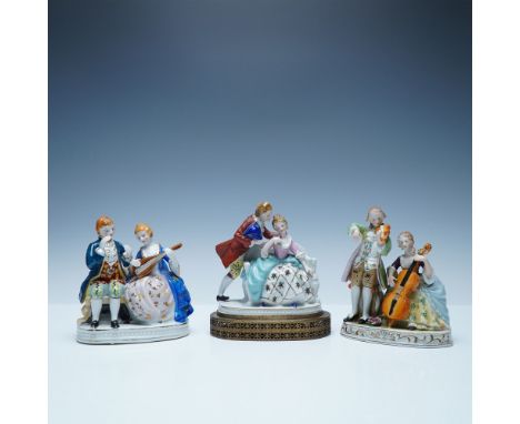 A delightful set of three hand-painted porcelain figurines, including pieces marked "Maruyama Made in Occupied Japan" alongsi