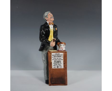This Royal Doulton figurine, titled The Auctioneer (HN2988), depicts a lively auctioneer standing at his podium, gavel in han