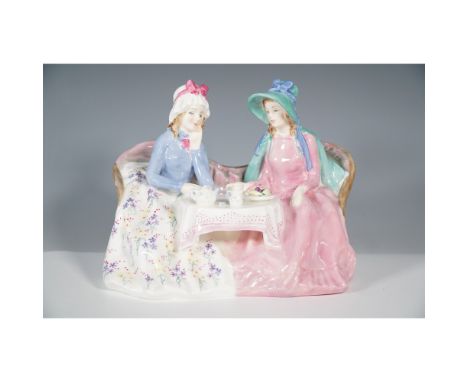 A charming Royal Doulton figurine titled Afternoon Tea HN1747, designed in 1936. This elegant porcelain piece features two fi