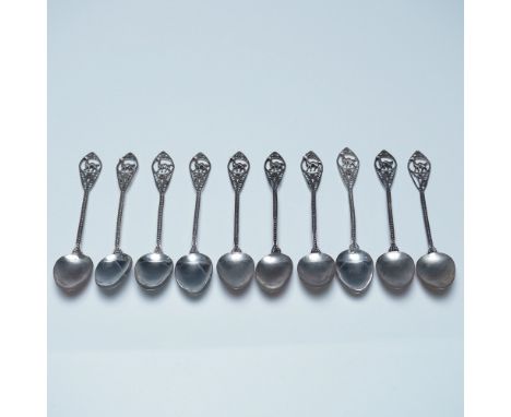 A finely crafted set of 10 filigree metal spoons, each showcasing an intricate openwork handle adorned with a detailed llama 