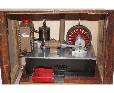 A wooden cased model of a beam engine powered by a stirling cycle hot air engine with spirit burner beneath large cylinder 13