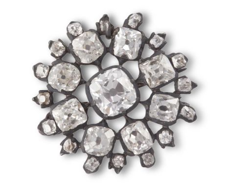 A DIAMOND BROOCH, SECOND HALF OF THE 19TH CENTURYA cushion-shaped diamond to the centre, to radiating spokes and border of si