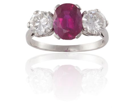 A FINE RUBY AND DIAMOND RINGThe cushion-shaped ruby, weighing approximately 2.30cts, between two round brilliant-cut diamond 