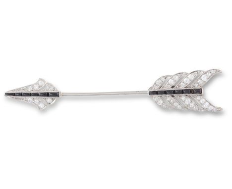 A DIAMOND AND ONYX ARROW JABOT PIN, CIRCA 1900The fletching and arrowhead set throughout with old brilliant and single-cut di