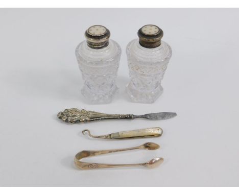 An Edward VII silver and mother of pearl folding button hook, Sheffield 1904, manicure implement, pair of silver sugar tongs,