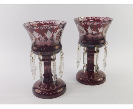 A pair of Bohemian late 19thC ruby flashed glass lustres, with etched rococo decoration, with faceted glass drops, 25.5cm hig