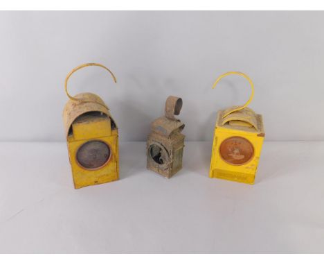 A Miller lamp and two yellow road works warning lamps.