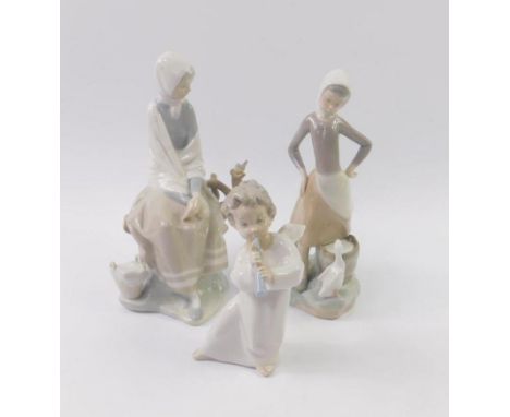 A Lladro porcelain figure of a lady seated on a branch with a song bird, girl with a duck drinking milk from a pail and a che
