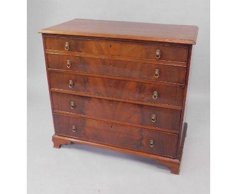 A Georgian mahogany secretaire chest of drawers, secretaire drawer opening to reveal drawers and recesses, over three long dr