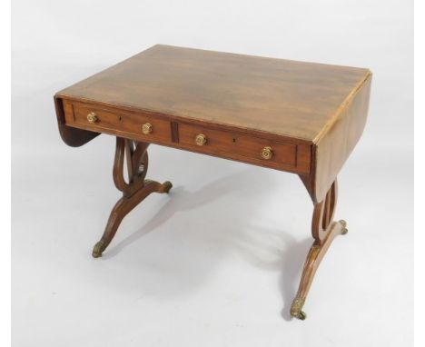 A Regency mahogany sofa table, the rectangular top with a broad boxwood and ebony string and crossbanded border, above two sh