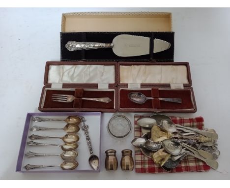 A selection of silver and silver plated spoons to include souvenir together with a silver handled cake slice, pair of silver 