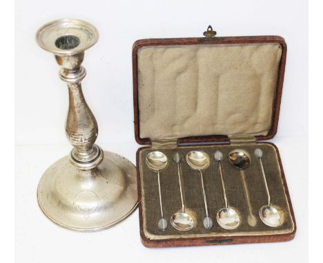 A cased set of six silver bean spoons and an eastern white metal candlestick.  