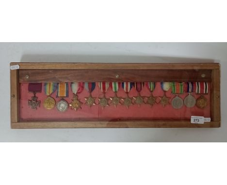 A wooden case display of medals to include 1914 - 15 star medal awarded to P. 2310. L-CPL. T. Dalton. M.F.P. , a 1914-1918 st