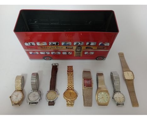 A tin containing seven watches, Timex, Rotary, etc.  