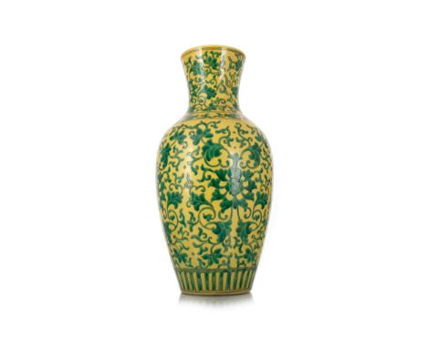 decorated with green scrolling foliage, on a yellow ground, the base with six character Kangxi mark in underglaze blue 42cm h
