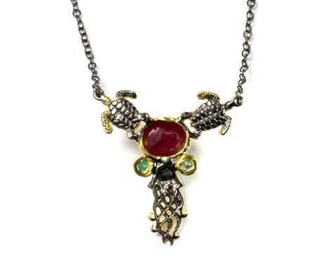 A Hana Maae designer 925 silver gilt pendant and chain set with a cabochon cut ruby and emeralds.