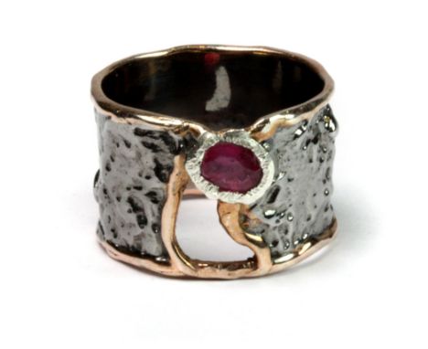 A Hana Maae designer 925 silver gilt ring set with an oval cut ruby (S).