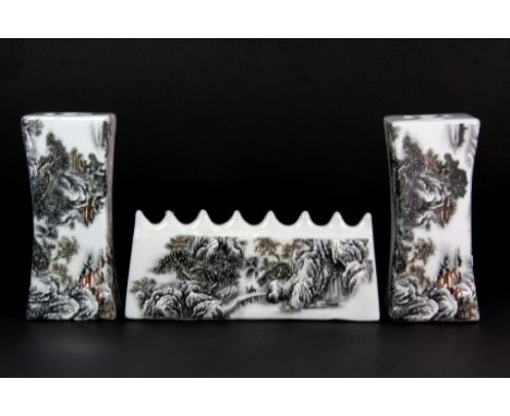 A mid 20th century Chinese porcelain brush rest (W. 15cm), together with a pair of matching scroll weights all depicting wint