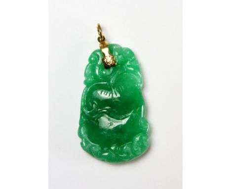 A lovely apple green jadeite jade pendant with gilt fastening, L. 4cm. Private estate purchased c. 1973.