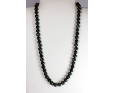 A polished jade bead necklace.