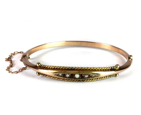 A lovely Victorian 9ct rose gold bangle set with rubies and seed pearls.