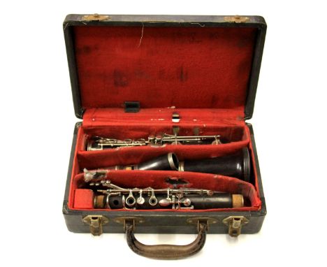 A cased rosewood clarinet by Boosey & Hawkes.