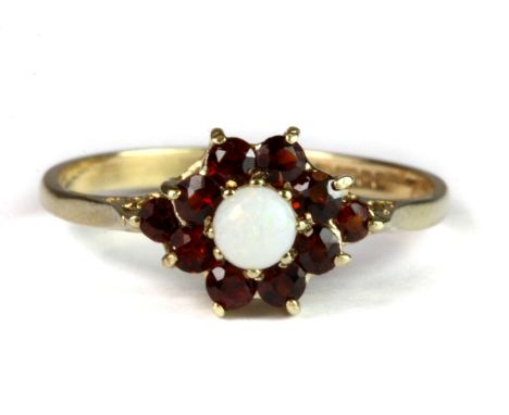 A 9ct yellow gold opal and garnet cluster ring (P).