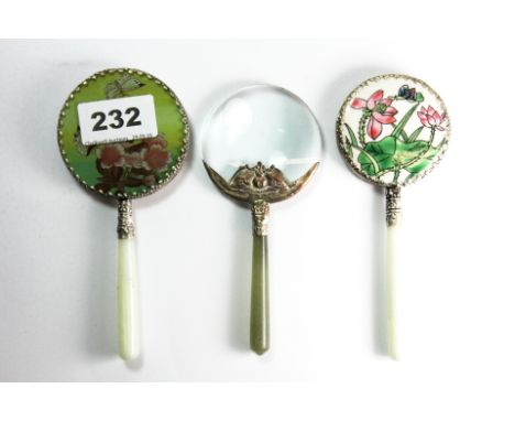 Two Chinese jade handled hand mirrors and a magnifying glass.