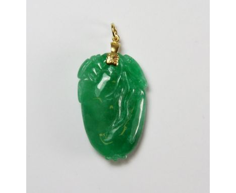 A lovely apple green jadeite jade gaud pendant, L. 3.5cm with gilt fastener. Private estate purchased c. 1973.