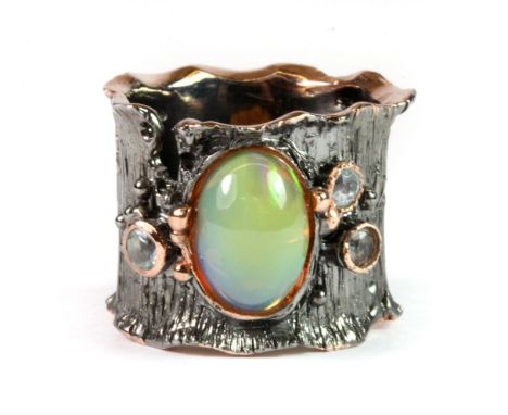 A Hana Maae designer 925 silver gilt ring set with a 3ct fire opal and blue topaz, (R).