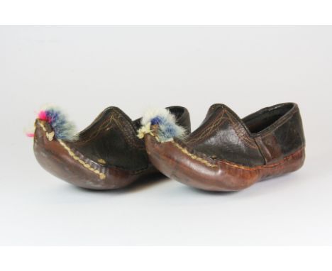 A pair of small miniature eastern leather shoes brought back from Mesopotamia in the First World War, L. 15cm.