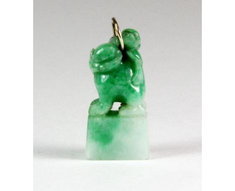 A lovely Chinese carved apple green jadeite jade lion dog pendant, H. 2.5cm.