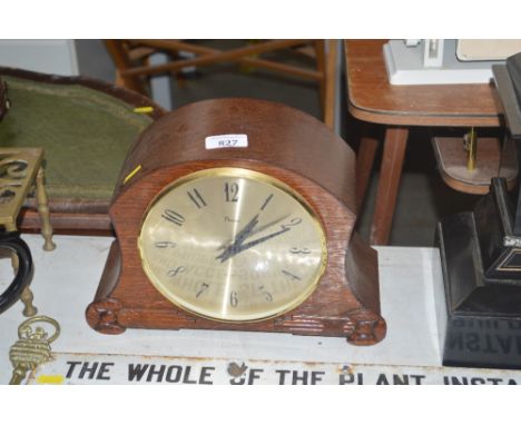 An oak cased quartz mantle clock