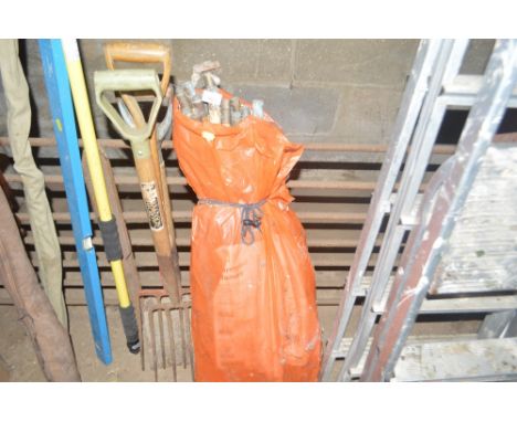 A quantity of tools and a bundle of draining rods