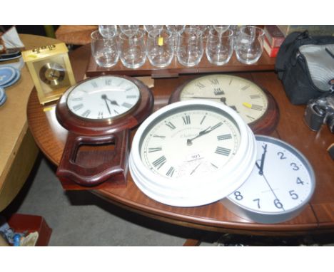Four walls clocks and a mantle clock