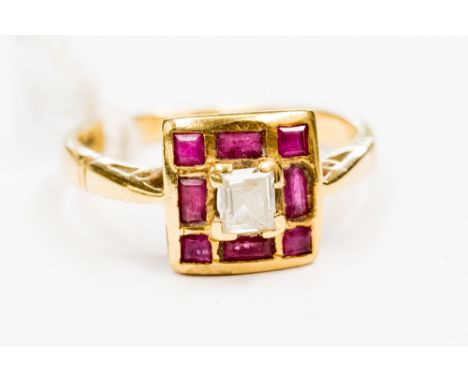 An 18ct ruby and diamond ring, with a square setting, set with square and rectangular rubies surrounding a central rectangula