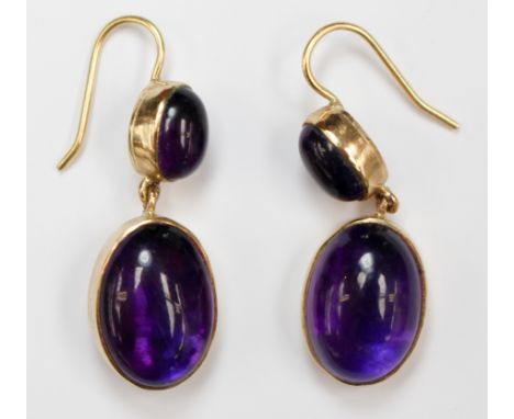 A pair of 9ct gold and cabachon amethyst set drop earrings on hook fastenings. The earrings comprise of two oval amethysts wi