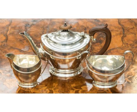 A silver three piece tea service; teapot, cream and sugar, Birmingham 1924, Henry Matthews, teapot weighing approx 13.26 ozt,