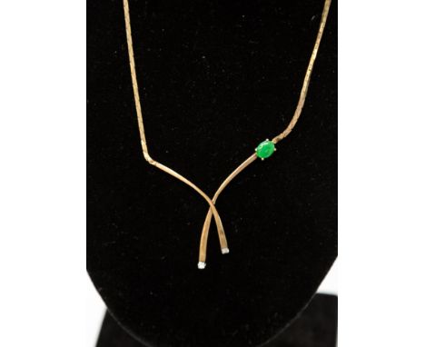 A 9ct gold jade and diamond set necklace, with cross over bar details set at the ends with two brilliant cut diamonds with a 