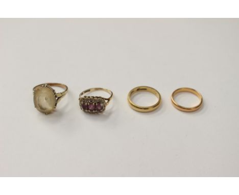 An 18ct gold wedding band, approx 3.9 grams, a 22ct gold wedding band approx 2.9 grams; together with an amethyst ring and a 