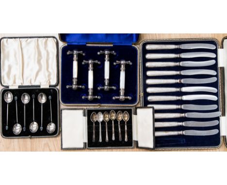 Two boxed sets of coffee spoons - coffee bean Sheffield 1934 and Birmingham 1953, a boxed quartet of knife rests, white metal