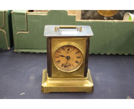 An American musical carriage clock, the dial with subsidiary dials, embossed face, raised on a plinth base