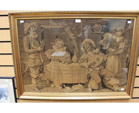 An early 20th Century machine woven tapestry depicting people in a tavern, fitted in a gilt frame 