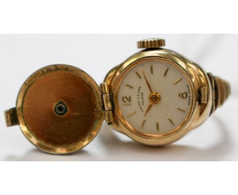 A Favre-Leuba Geneve watch, ring in yellow metal with a finger size L, set with white stones and pearl to the centre and case