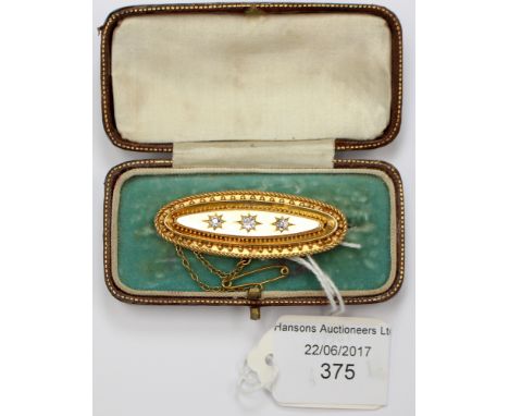 A 15ct Victorian brooch with three old cut diamonds with a total weight approx 0.35ct, star set. The brooch is a lozenge shap