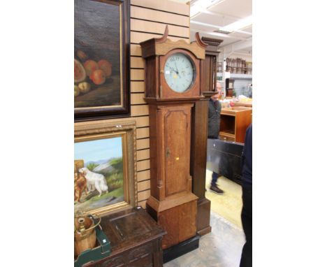 A George III oak 30 hour longcase clock, having a white enamelled dial, with hand painted decoration, the case with mahogany 