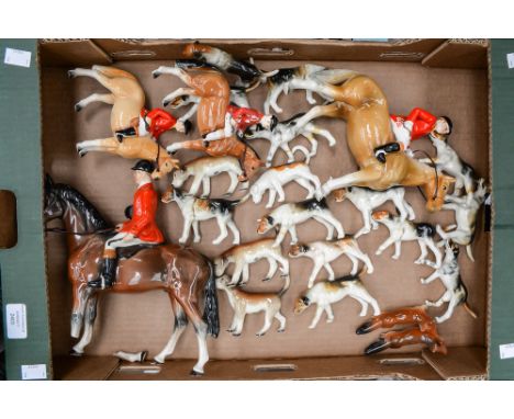 Four Beswick style horseback riders, seventeen Beswick style hunting dogs and two foxes, many pieces being restored and as fo