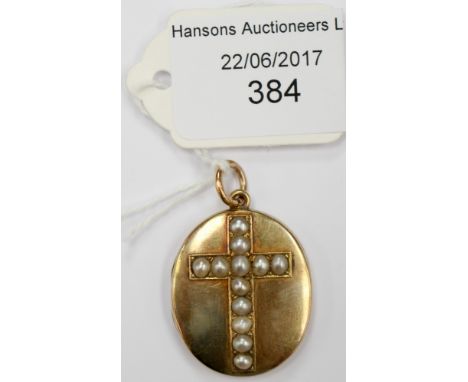 A late Victorian yellow metal and half pearl set oval locket, the pearls forming a cross to centre, measuring approx 3cm x 2.
