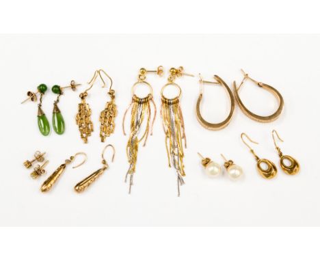 A collection of eight pairs of 9ct gold earrings comprising of one three colour drop chain earrings, one pair large textures 