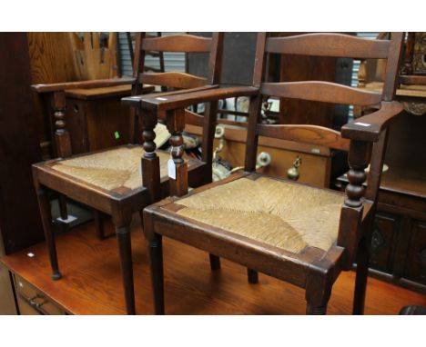 A pair of Arts and Crafts Morris & Co. style ladder-back armchairs, with drop in rush seats